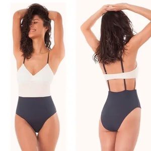 Lively color block-white, light pink, navy one piece.  NEVER WORN, size L